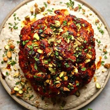 Whole Roasted Cauliflower with Harissa Glaze and White Bean Puree